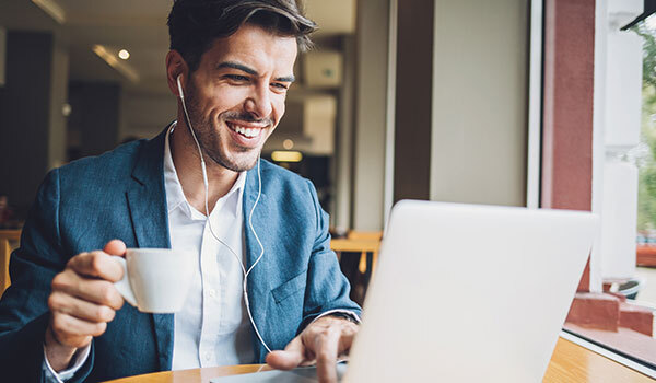 Smiling man an at computer